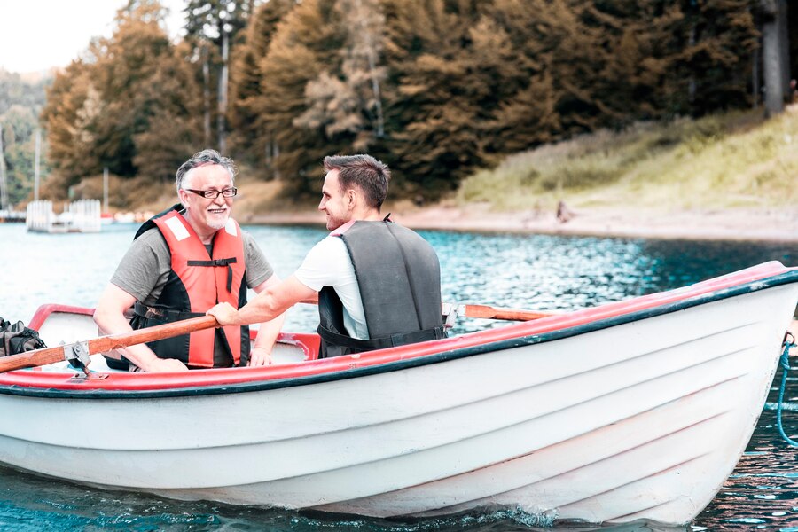 two-men-rowing-boat-tranquil-lake